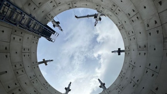 view from the bottom of a storage tank looking up at the blue sky