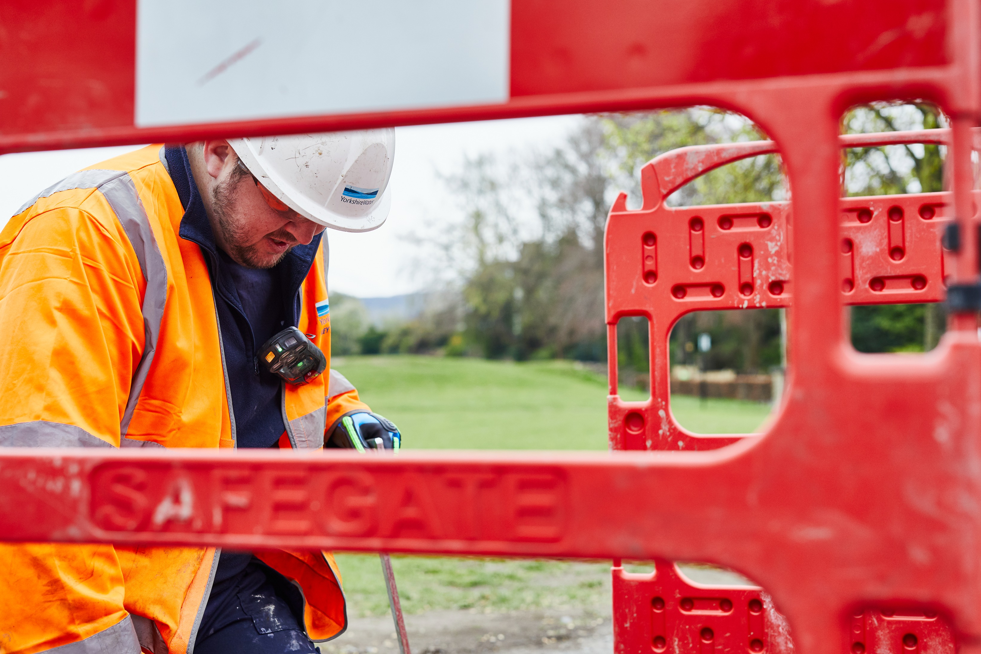 YW Colleague in high vis working within safety barriers