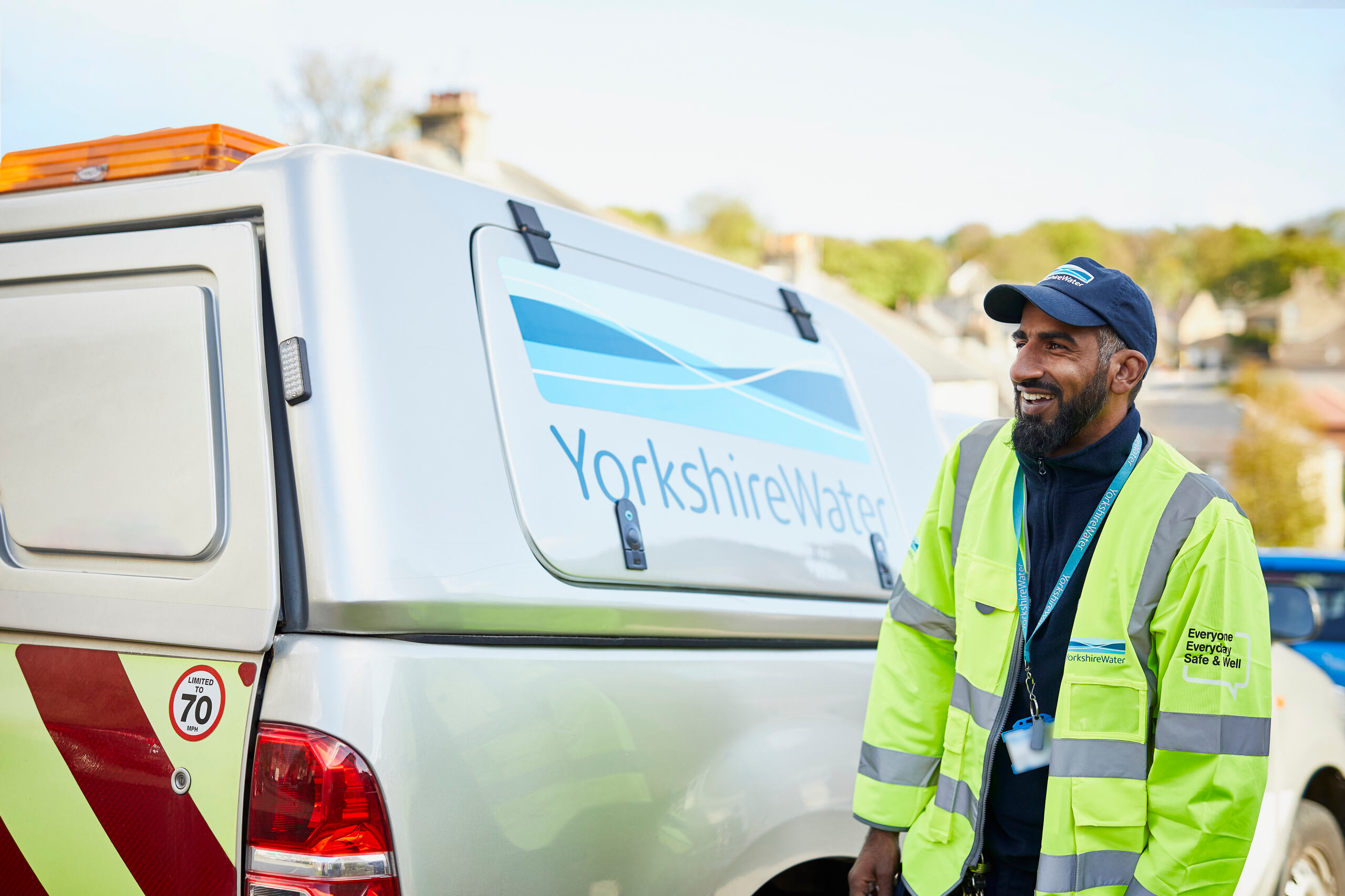 YW colleague in PPE stood beside a YW branded van